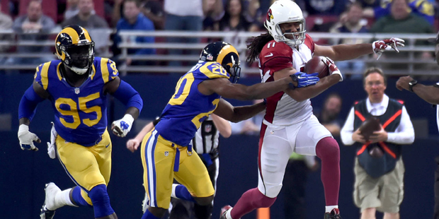 Arizona Cardinals wide receiver Larry Fitzgerald, right, is pushed out of bounds by St. Louis Rams ...