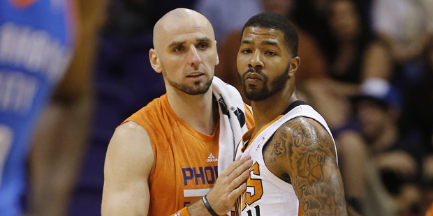 Phoenix Suns' Marcin Gortat, of Poland, slaps Markieff Morris on the chest after Morris was ejected...