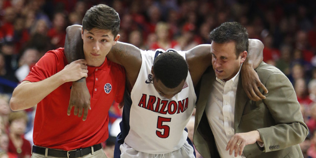 Arizona guard Kadeem Allen (5) is helped off the court with trainers during the first half of an NC...