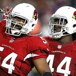 Arizona Cardinals linebacker Dwight Freeney (54) salutes the fans with teammate Markus Golden (44) after his sack in Baltimore Ravens quarterback Joe Flacco during the second half of an NFL football game, Monday, Oct. 26, 2015, in Glendale, Ariz. (AP Photo/Rick Scuteri)