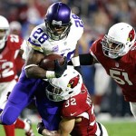Minnesota Vikings running back Adrian Peterson (28) is tackled by Arizona Cardinals free safety Tyrann Mathieu (32) and linebacker Kevin Minter (51) during the first half of an NFL football game, Thursday, Dec. 10, 2015, in Glendale, Ariz. (AP Photo/Ross D. Franklin)