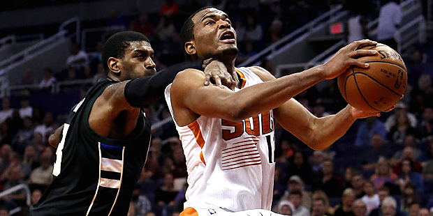 Milwaukee Bucks guard O.J. Mayo, left, fouls Phoenix Suns forward T.J. Warren in the fourth quarter...