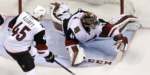 A shot by St. Louis Blues' Kevin Shattenkirk slips past Arizona Coyotes goalie Mike Smith, right, a...