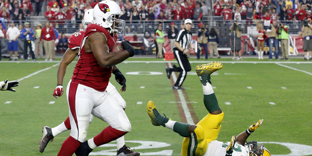 Arizona Cardinals defensive end Cory Redding (90) runs in a fumble recovery for a touchdown as Gree...