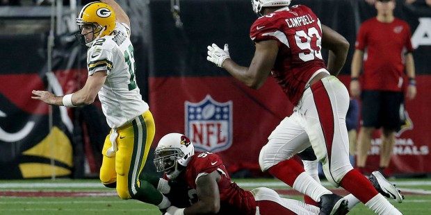 Green Bay Packers quarterback Aaron Rodgers (12) is tackled by Arizona Cardinals defensive end Fros...