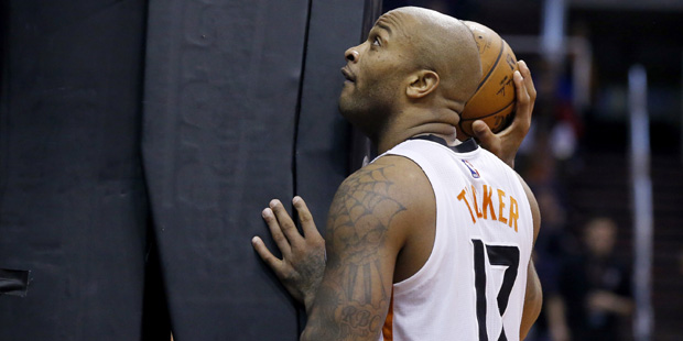 Phoenix Suns' P.J. Tucker pauses with the basketball after a Suns turnover to the Denver Nuggets du...