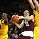 Texas A&M guard Alex Caruso (21) drives between Arizona State guard Gerry Blakes (4) and Eric Jacobsen during the first half of an NCAA college basketball game, Saturday, Dec. 5, 2015, in Tempe, Ariz. (AP Photo/Rick Scuteri)