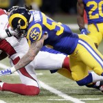 Arizona Cardinals wide receiver Michael Floyd, left, is stopped by St. Louis Rams linebacker James Laurinaitis after catching a pass for a 12-yard gain during the second quarter of an NFL football game on Sunday, Dec. 6, 2015, in St. Louis. (AP Photo/Tom Gannam)