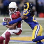 Arizona Cardinals wide receiver Larry Fitzgerald, left, catches a 15-yard pass as St. Louis Rams cornerback Janoris Jenkins defends during the second quarter of an NFL football game on Sunday, Dec. 6, 2015, in St. Louis. (AP Photo/Tom Gannam)