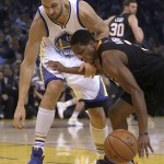 Phoenix Suns' Brandon Knight, right, keeps the ball from Golden State Warriors' Andrew Bogut (12) during the first half of an NBA basketball game Wednesday, Dec. 16, 2015, in Oakland, Calif. (AP Photo/Ben Margot)