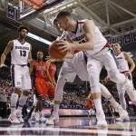 Gonzaga's Domantas Sabonis (11) grabs a rebound in front of teammate Kyle Wiltjer during the first half of an NCAA college basketball game against Arizona, Saturday, Dec. 5, 2015, in Spokane, Wash. (AP Photo/Young Kwak)
