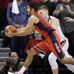 Arizona's Elliott Pitts, front, goes after a rebound against Gonzaga's Domantas Sabonis during the second half of an NCAA college basketball game, Saturday, Dec. 5, 2015, in Spokane, Wash. Arizona won 68-63. (AP Photo/Young Kwak)