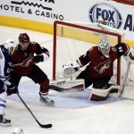 
              Arizona Coyotes goalie Louis Domingue (35) makes the save against Winnipeg Jets right wing Drew Stafford (12) in the second period during an NHL hockey game, Thursday, Dec. 31, 2015, in Glendale, Ariz. (AP Photo/Rick Scuteri)
            
