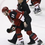 Arizona Coyotes' Oliver Ekman-Larsson (23) is helped off the ice by a member of the training staff during the third period of an NHL hockey game against the Chicago Blackhawks, Tuesday, Dec. 29, 2015, in Glendale, Ariz. The Blackhawks won 7-5. (AP Photo/Ross D. Franklin)