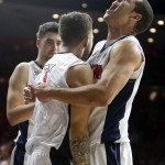 Arizona forward Ryan Anderson, right, celebrates after getting fouled with Gabe York, center, and Dusan Ristic during the first half of an NCAA college basketball game against Fresno State, Wednesday, Dec. 9, 2015, in Tucson, Ariz. (AP Photo/Rick Scuteri)