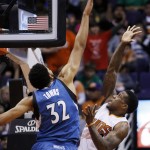 Minnesota Timberwolves' Karl-Anthony Towns (32) blocks the shot of Phoenix Suns' Eric Bledsoe, right, during the second half of an NBA basketball game Sunday, Dec. 13, 2015 in Phoenix. The Suns defeated the Timberwolves 108-101. (AP Photo/Ross D. Franklin)