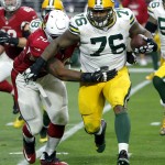 Green Bay Packers defensive end Mike Daniels (76) runs back an interception as Arizona Cardinals tackle Bobby Massie (70) defends during the first half of an NFL football game, Sunday, Dec. 27, 2015, in Glendale, Ariz. (AP Photo/Ross D. Franklin)
