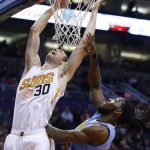 Phoenix Suns' Jon Leuer (30) scores against Denver Nuggets' Kenneth Faried, right, during the first half of an NBA basketball game Wednesday, Dec. 23, 2015, in Phoenix. (AP Photo/Ross D. Franklin)