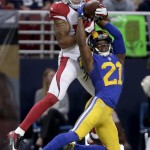 St. Louis Rams cornerback Janoris Jenkins (21) breaks up a pass intended for Arizona Cardinals wide receiver Michael Floyd during the second quarter of an NFL football game on Sunday, Dec. 6, 2015, in St. Louis. (AP Photo/Tom Gannam)