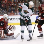 Minnesota Wild's Nino Niederreiter (22), of Switzerland, and Arizona Coyotes' Nicklas Grossmann (2), of Sweden, wait for the puck in front of Coyotes goalie Anders Lindback (29), of Sweden, during the first period of an NHL hockey game Friday, Dec. 11, 2015 in Glendale, Ariz. (AP Photo/Ross D. Franklin)