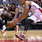 Phoenix Suns guard Brandon Knight, left, battles for the ball against Washington Wizards center Ryan Hollins, right, during the first half of an NBA basketball game, Friday, Dec. 4, 2015, in Washington. (AP Photo/Nick Wass)