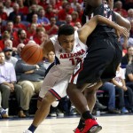 Arizona guard Allonzo Trier, left, drives around Fresno State center Terrell Carter II during the second half of an NCAA college basketball game, Wednesday, Dec. 9, 2015, in Tucson, Ariz. (AP Photo/Rick Scuteri)