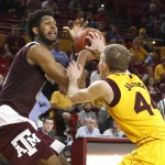 Texas A&M center Tonny Trocha-Morelos, left, and Arizona State guard Kodi Justice battle for the ball during the first half of an NCAA college basketball game, Saturday, Dec. 5, 2015, in Tempe, Ariz. (AP Photo/Rick Scuteri)