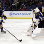 St. Louis Blues goalie Jake Allen, right, clears a puck past Arizona Coyotes' Max Domi (16) during the third period of an NHL hockey game, Tuesday, Dec. 8, 2015, in St. Louis. The Blues won 4-1. (AP Photo/Jeff Roberson)
