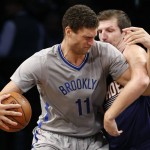Brooklyn Nets center Brook Lopez (11) gets tangled up with Phoenix Suns forward Mirza Teletovic in the first half of an NBA basketball game at the Barclays Center, Tuesday, Dec. 1, 2015, in New York. (AP Photo/Kathy Willens)