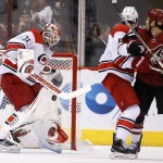 Carolina Hurricanes' Eddie Lack (31), of Sweden, makes a save on a shot as Hurricanes' Noah Hanifin (5) and Arizona Coyotes' Steve Downie (17) watch during the first period of an NHL hockey game Saturday, Dec. 12, 2015 in Glendale, Ariz. (AP Photo/Ross D. Franklin)
