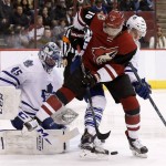 Arizona Coyotes' Anthony Duclair (10) tries to control the puck in front of Toronto Maple Leafs goalie Jonathan Bernier (45) as Maple Leafs' Martin Marincin, right, of the Czech Republic, defends during the first period of an NHL hockey game Tuesday, Dec. 22, 2015, in Glendale, Ariz. (AP Photo/Ross D. Franklin)