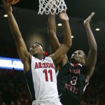 Arizona guard Allonzo Trier drives past Fresno State guard Paul Watson (3) during the second half of an NCAA college basketball game, Wednesday, Dec. 9, 2015, in Tucson, Ariz. (AP Photo/Rick Scuteri)