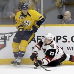 Arizona Coyotes defenseman Oliver Ekman-Larsson (23), of Sweden, and Nashville Predators left wing Cody Bass (16) battle for the puck in the second period of an NHL hockey game, Tuesday, Dec. 1, 2015, in Nashville, Tenn. (AP Photo/Mark Humphrey)