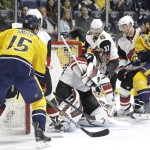 Arizona Coyotes goalie Mike Smith (41) blocks a shot as Nashville Predators center Craig Smith (15) and Cody Hodgson (11) watch for the rebound in the second period of an NHL hockey game, Tuesday, Dec. 1, 2015, in Nashville, Tenn. (AP Photo/Mark Humphrey)