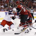Columbus Blue Jackets' David Clarkson (23) battles Arizona Coyotes' Klas Dahlbeck (34), of Sweden, for the puck as Blue Jackets' Boone Jenner (38) closes in during the first period of an NHL hockey game, Thursday, Dec. 17, 2015, in Glendale, Ariz. (AP Photo/Ross D. Franklin)