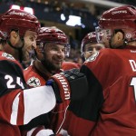 Arizona Coyotes' Shane Doan (19) celebrates the first goal against the Toronto Maple Leafs with teammates Kyle Chipchura (24) and Brad Richardson, middle, during the first period of an NHL hockey game Tuesday, Dec. 22, 2015, in Glendale, Ariz. (AP Photo/Ross D. Franklin)