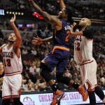 Phoenix Suns' Eric Bledsoe (2), goes up for a shot against Chicago Bulls' Taj Gibson (22), and Joakim Noah (13), during the second half of a basketball game Monday, Dec. 7, 2015, in Chicago. Phoenix won 103-101. (AP Photo/Paul Beaty)