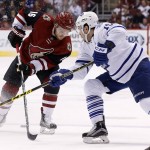 Arizona Coyotes' Max Domi (16) passes the puck between his legs as Toronto Maple Leafs' P.A. Parenteau, right, defends during the first period of an NHL hockey game Tuesday, Dec. 22, 2015, in Glendale, Ariz. (AP Photo/Ross D. Franklin)