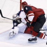 Arizona Coyotes' Viktor Tikhonov (9), of Russia, beats Columbus Blue Jackets' Curtis McElhinney, left, for a goal during the second period of an NHL hockey game, Thursday, Dec. 17, 2015, in Glendale, Ariz. (AP Photo/Ross D. Franklin)