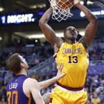 Cleveland Cavaliers' Tristan Thompson (13) dunks in front of Phoenix Suns' Jon Leuer (30) during the first half of an NBA basketball game Monday, Dec. 28, 2015, in Phoenix. (AP Photo/Ross D. Franklin)