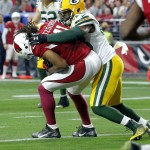 Arizona Cardinals wide receiver Larry Fitzgerald (11) makes a touchdown catch as Green Bay Packers linebacker Joe Thomas (48) defends during the first half of an NFL football game, Sunday, Dec. 27, 2015, in Glendale, Ariz. (AP Photo/Ross D. Franklin)