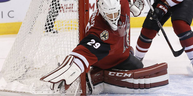 Arizona Coyotes' Anders Lindback, of Sweden, makes a save on a shot by the Carolina Hurricanes duri...