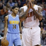Phoenix Suns' P.J. Tucker (17) puts his hands together fter being called for a foul on Denver Nuggets' Gary Harris (14) during the second half of an NBA basketball game Wednesday, Dec. 23, 2015, in Phoenix. (AP Photo/Ross D. Franklin)