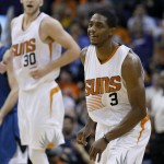 Phoenix Suns' Brandon Knight (3) smiles after making a 3-point shot against the Minnesota Timberwolves as teammate Jon Leuer (30) shouts in celebration during the second half of an NBA basketball game Sunday, Dec. 13, 2015 in Phoenix.  The Suns defeated the Timberwolves 108-101. (AP Photo/Ross D. Franklin)