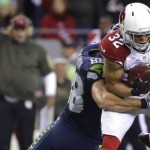 Arizona Cardinals free safety Tyrann Mathieu is tackled by Seattle Seahawks tight end Jimmy Graham after he intercepted a pass during the second half of an NFL football game, Sunday, Nov. 15, 2015, in Seattle. (AP Photo/Elaine Thompson)