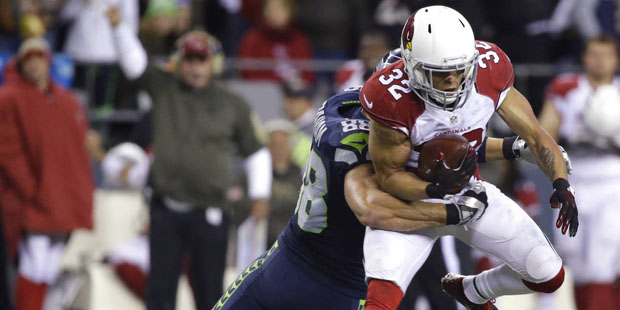 Arizona Cardinals free safety Tyrann Mathieu is tackled by Seattle Seahawks tight end Jimmy Graham ...