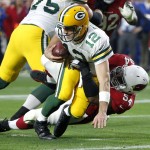 Green Bay Packers quarterback Aaron Rodgers (12) is sacked by Arizona Cardinals inside linebacker Dwight Freeney during the second half of an NFL football game, Sunday, Dec. 27, 2015, in Glendale, Ariz. (AP Photo/Ross D. Franklin)