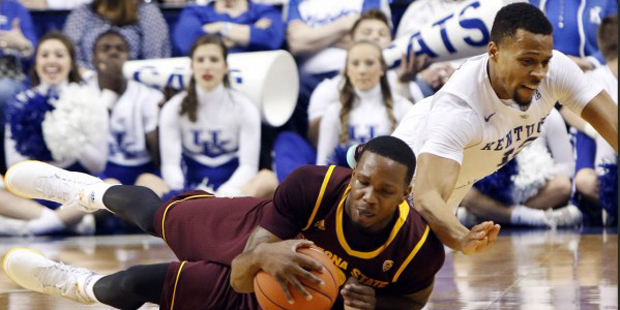 Kentucky's Isaiah Briscoe, right, and Arizona State's Willie Atwood dive for a loose ball during th...