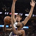 Phoenix Suns forward Cory Jefferson (55) attempts to shoot against San Antonio Spurs center Boban Marjanovic, of Serbia, during the first half of an NBA basketball game, Wednesday, Dec. 30, 2015, in San Antonio. (AP Photo/Darren Abate)
