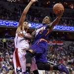 Phoenix Suns guard Eric Bledsoe (2) goes to the basket against Washington Wizards forward Otto Porter Jr. (22) during the first half of an NBA basketball game Friday, Dec. 4, 2015, in Washington. (AP Photo/Nick Wass)
